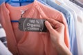 Woman Holding Label Showing 100 Percent Organic Cotton