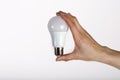 Close up of woman`s hand holding light bulb. Royalty Free Stock Photo