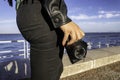Close up of a woman`s hand holding a professional film camera shooting in the streets of Lisbon in Portugal