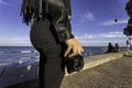 Close up of a woman`s hand holding a professional film camera shooting in the streets of Lisbon in Portugal