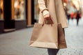 Close up of woman`s hand holding shopping bags while walking on the street Royalty Free Stock Photo