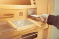 Close-up of woman`s hand inserting debit card into an ATM machin Royalty Free Stock Photo