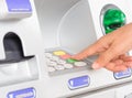 Close-up of woman`s hand inserting debit card into an ATM machin Royalty Free Stock Photo