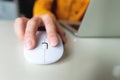 close-up, a woman's hand lies on a white mouse from a laptop, a freelancer's workflow Royalty Free Stock Photo