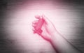 Close-up of woman`s hand lying on the ground with holding a pressurized cartridge inhaler extended pharynx, Bronchodilator. Black