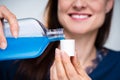 Woman Pouring Mouthwash In To Cap