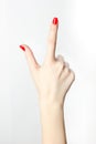 Close-up of woman`s hand with red nails pointing index finger on white background. Royalty Free Stock Photo