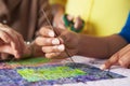 Close Up Of Woman's Hand Sewing Quilt