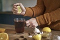 woman's hand squeezing lemon for tea Royalty Free Stock Photo