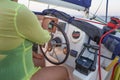 Close-up of a woman`s hand on the steering wheel of a yacht. Yachts woman`s hands on the yacht`s steering wheel. Close view Royalty Free Stock Photo