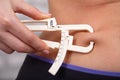 Woman Measuring Her Body Fat With Caliper Royalty Free Stock Photo