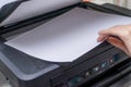Close up Woman's hand with working copier, printer Royalty Free Stock Photo