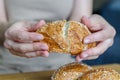 Close-up of woman& x27;s hands breaking bread in half. Making sandwiches.