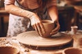 Close-up of a woman\'s hands in a ceramic workshop working with clay on a potter\'s wheel. Generative AI