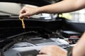 Close up of woman's hands checking oil level in car engine Woman checking oil level in car engine at home Royalty Free Stock Photo