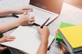 Close up of woman`s hands hold pen and writing in notepad Royalty Free Stock Photo