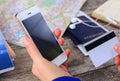 Close-up woman's hands holding a credit card and using cell phone Royalty Free Stock Photo