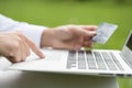 Close-up woman's hands holding a credit card and using computer Royalty Free Stock Photo