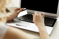 Close-up woman`s hands holding a credit card and using computer keyboard for online shopping. Royalty Free Stock Photo