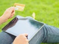 Close-up woman`s hands holding a credit card and using tablet pc for online shopping Royalty Free Stock Photo