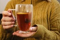 Close up of woman& x27;s hands holding a glass cup with hot tea with lemon and honey Royalty Free Stock Photo