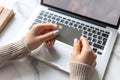 Close up of a woman& x27;s hands holding a gray credit card in front of a laptop computer Royalty Free Stock Photo