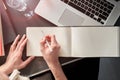 Close up of woman`s hands making notes on white spread book. Young woman or student working and writing on paper notebook, space Royalty Free Stock Photo