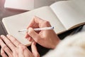 Close up of woman`s hands making notes. Young woman or student working and writing on paper notebook, space for text. Royalty Free Stock Photo