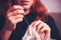 Close up on woman's hands sewing