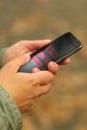 Close up of woman`s hands with smartphone and copying data lettering. Scam and fraud