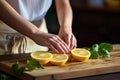 Close up of woman\'s hands squeezing lemon on wooden cutting board.Generative AI