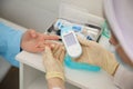 Close up of woman`s hands using lancet on finger to check blood sugar level by glucose meter, Healthcare medical and Royalty Free Stock Photo