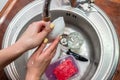 Close up woman`s hands of washing dishes in kitchen sink. Cleaning chores Royalty Free Stock Photo