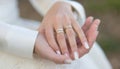 a close up of a woman s hands with wedding rings on them