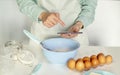 Close up of a woman's hands whipping eggs for making dough