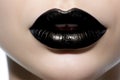 Close up of woman\'s lips with bold black lipstick