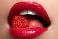 Close-up of woman's lips with bright fashion red glossy makeup