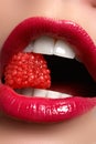 Close-up of woman's lips with bright fashion red glossy makeup. Macro bloody lipgloss make-up. Red lips. Open mouth Royalty Free Stock Photo