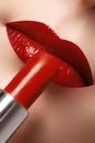 Close-up of woman`s lips with fashion red make-up. Beautiful fem