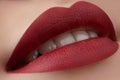 Close-up of woman's lips with fashion red make-up. Beautiful female mouth, full lips with perfect makeup. Classic visage