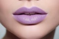 Close up of woman\'s lips with pastel violet lipstick