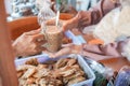 Close up of a woman`s stall waitress` hand holding a drinking glass