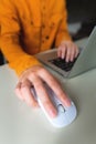 Close-up woman searching and clicking mouse using laptop, online shopping concept. Blurred background Royalty Free Stock Photo