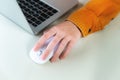 Close-up woman searching and clicking mouse using laptop, online shopping concept. Blurred background Royalty Free Stock Photo