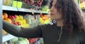 Close up of woman selecting fresh orange in grocery store supermarket sale, shopping marketplace. Young woman choosing Royalty Free Stock Photo