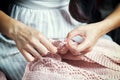 Close-up of a woman sews a button