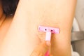 Close-up of woman shaving her armpits