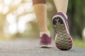 Close up woman shoe running on the road, jogging alone at park, Sports healthy lifestyle concept