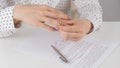 Close-up woman signed divorce papers and took off her wedding ring