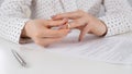 Close-up woman signed divorce papers and took off her wedding ring